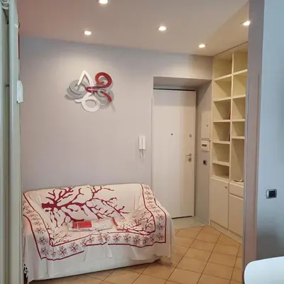 a room with a bed and a sign on the wall at Apt Osci in Rome