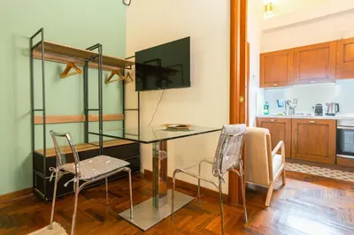 a kitchen with a glass table and two chairs at Stylish Studio in Sallustiano in Rome