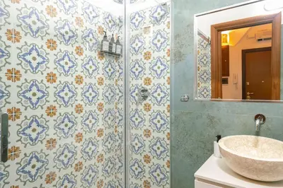 a bathroom with a sink and blue and white tiles at Stylish Studio in Sallustiano in Rome