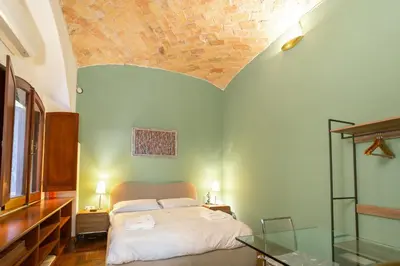 a bedroom with a bed and a brick ceiling at Stylish Studio in Sallustiano in Rome