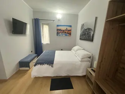 a bedroom with a bed and a flat screen tv at Alloggio Fiorella in Rome
