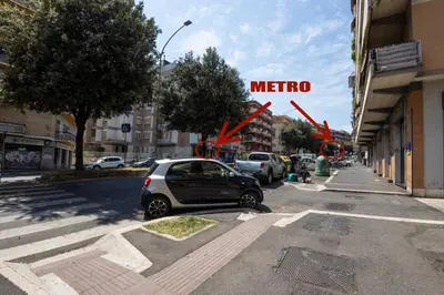 a car parked on a street with a metro sign at Be Max Guest House in Rome