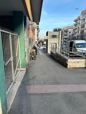 a person walking down a street next to a building at Be Max Guest House in Rome