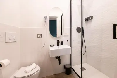 a bathroom with a toilet and a sink and a shower at Be Max Guest House in Rome
