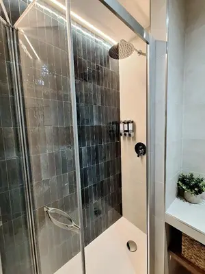a shower with a glass door in a bathroom at Deltis Boutique Apartments in Rome