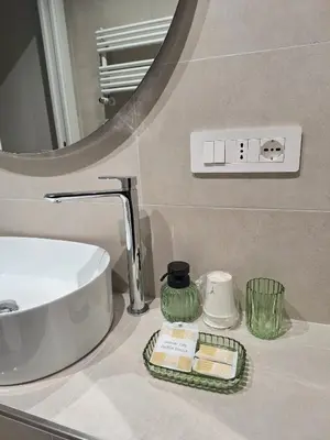 a bathroom counter with a sink and a mirror at Deltis Boutique Apartments in Rome