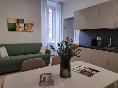 a living room with a table with a vase of flowers on it at Deltis Boutique Apartments in Rome