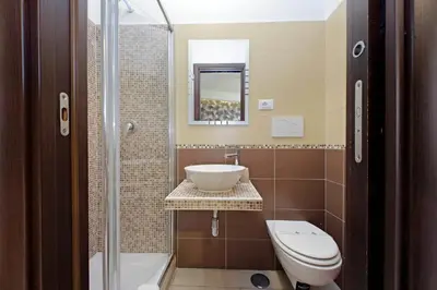 a bathroom with a sink and a toilet at Roma Suite Centro in Rome