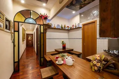 a room with a table with two mugs on it at Sancta Scala in Rome