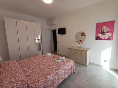 a bedroom with a bed and a dresser at Alessia C Locazione turistica in Rome