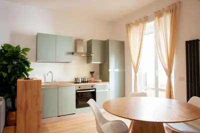 a kitchen with a table and a dining room at Casa Monteverde near Trastevere and the city center in Rome