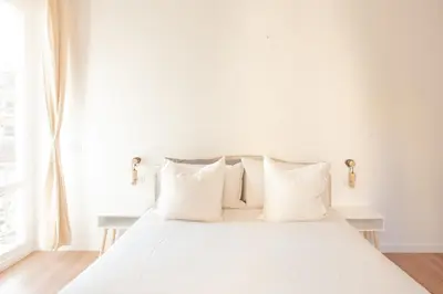 a white bed with white pillows and a window at Casa Monteverde near Trastevere and the city center in Rome