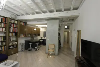 a living room with a desk and a table in a room at Grotte Apartment in Rome