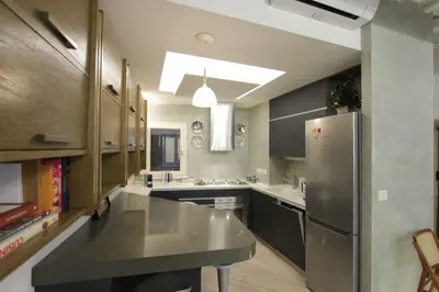 a large kitchen with a stainless steel refrigerator at Grotte Apartment in Rome