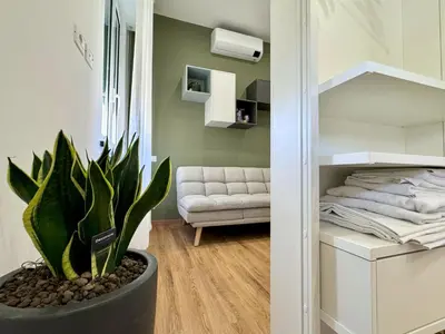 a living room with a couch and a plant at JHHIT - Panoramic Modern Penthouse in Rome