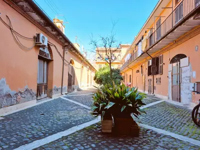 an empty street with some plants in an alley at Appartamento elegante con terrazzino a San Lorenzo in Rome