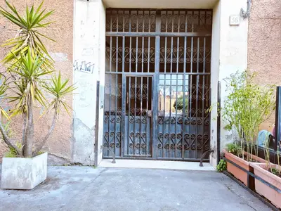 an entrance to a building with a metal door at Appartamento elegante con terrazzino a San Lorenzo in Rome