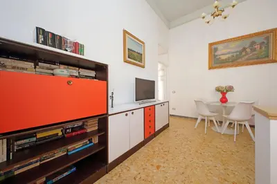 a living room with a television and a dining room table at 4BNB - Monteverde Chic & Comfort in Rome