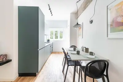 a kitchen and dining room with a table and chairs at Domus 50 in Rome