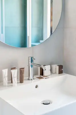 a bathroom sink with a faucet and a mirror at Domus 50 in Rome