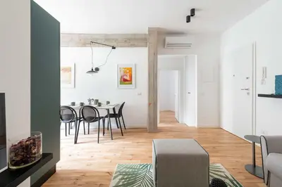 a living room and dining room with a table and chairs at Domus 50 in Rome