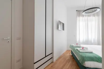 a bedroom with a bed and a mirror at Domus 50 in Rome