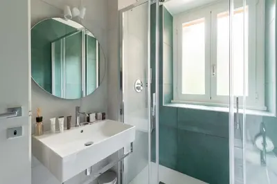 a bathroom with a sink and a mirror at Domus 50 in Rome