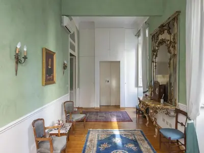 a hallway with chairs and a table and a mirror at Apartment Plinio by Interhome in Rome