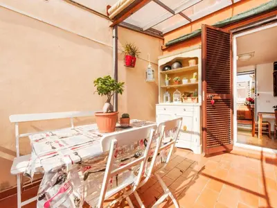 a kitchen and dining room with a table and chairs at Apartment La Terrazza by Interhome in Rome
