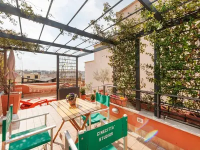 a rooftop patio with a table and chairs at Apartment La Terrazza by Interhome in Rome