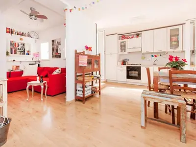 a living room with a red couch and a table at Apartment La Terrazza by Interhome in Rome