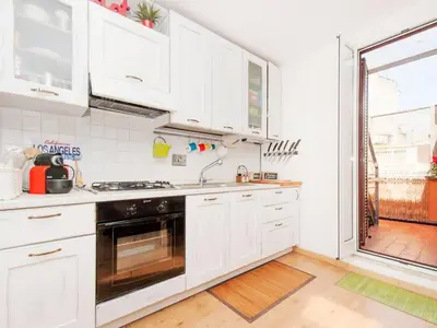 a white kitchen with a sink and a stove at Apartment La Terrazza by Interhome in Rome
