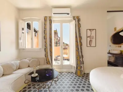 a living room with a couch and a bed and a window at Apartment La Dolce Vita by Interhome in Rome
