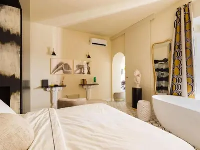 a bedroom with a white bed and a tub and a sink at Apartment La Dolce Vita by Interhome in Rome