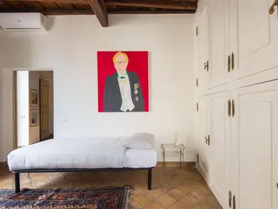 a bedroom with a bed and a painting on the wall at Apartment Pantheon View by Interhome in Rome