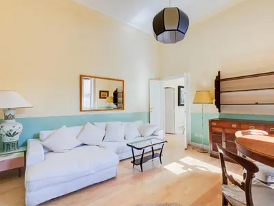 a living room with a white couch and a table at Apartment Babuino by Interhome in Rome