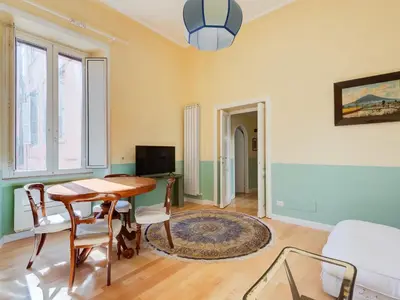 a living room with a table and chairs and a tv at Apartment Babuino by Interhome in Rome