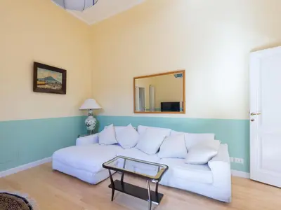 a living room with a white couch and a mirror at Apartment Babuino by Interhome in Rome