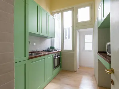 a green kitchen with a sink and a stove at Apartment Babuino by Interhome in Rome