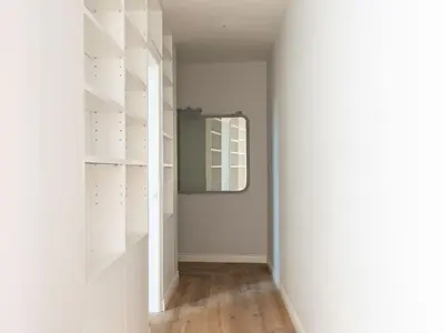 a hallway with white shelves and a mirror at Apartment Luminosa Vittoria by Interhome in Rome