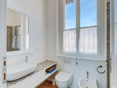 a white bathroom with a sink and a toilet at Apartment Luminosa Vittoria by Interhome in Rome