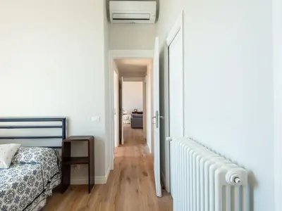 a bedroom with a bed and a hallway at Apartment Luminosa Vittoria by Interhome in Rome