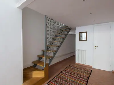 a spiral staircase in a room with a rug at Apartment Il Nido by Interhome in Rome