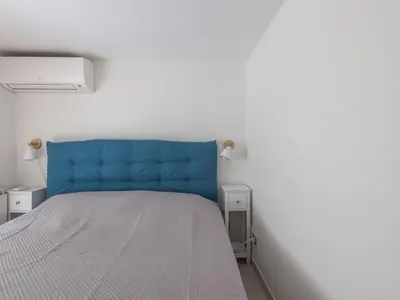 a bed with a blue headboard in a room at Apartment Il Nido by Interhome in Rome