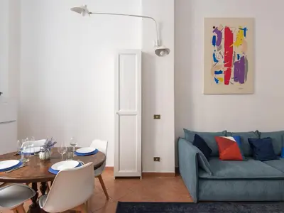 a living room with a blue couch and a table at Apartment Il Nido by Interhome in Rome