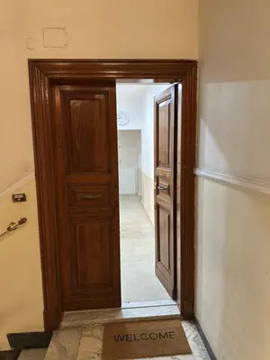 a wooden door in a room with a hallway at YouRoominRome in Rome