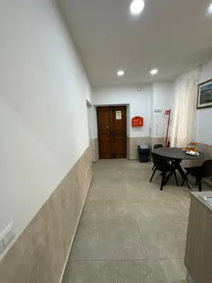 a room with a hallway with a table and a door at YouRoominRome in Rome