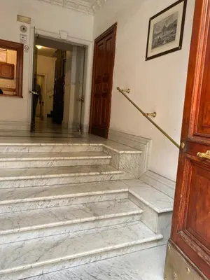 a stairway leading to a hallway with a door at YouRoominRome in Rome