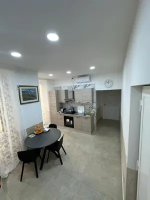 a kitchen and dining room with a table and chairs at YouRoominRome in Rome