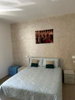 a bedroom with a bed and a picture on the wall at YouRoominRome in Rome